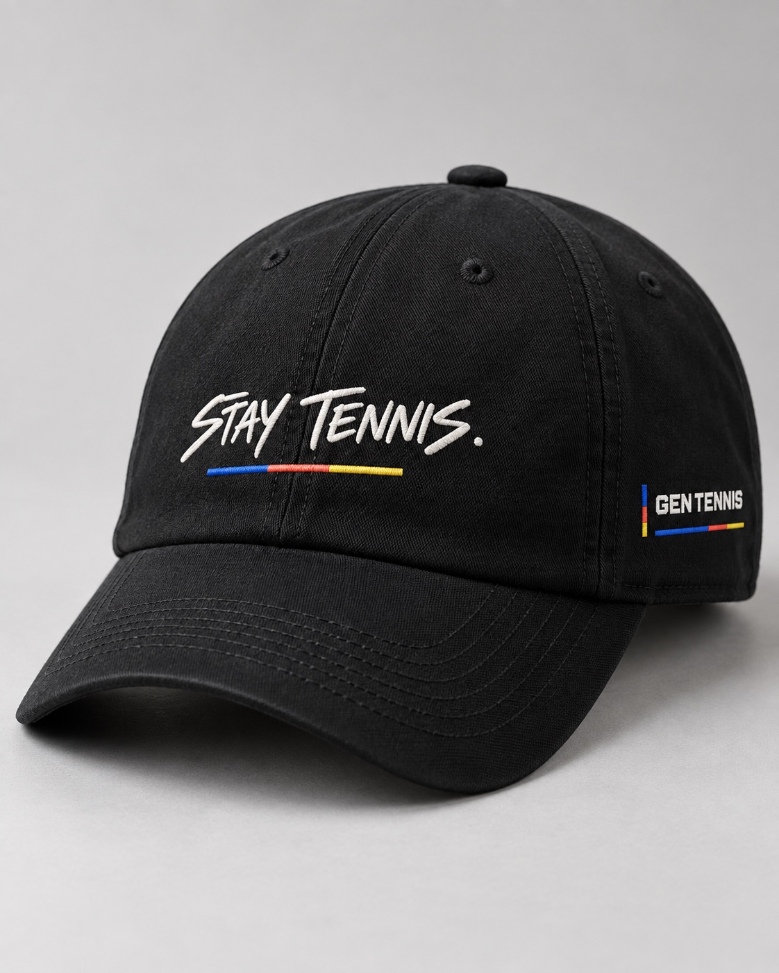 Black cap concept with white Stay Tennis script, colored underline and GEN Tennis side signature