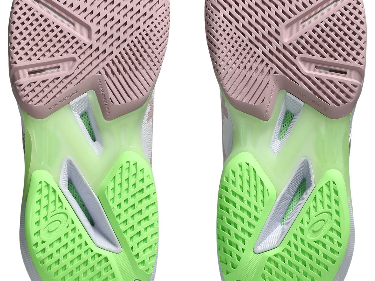 Close-up of pink forefoot tread, lime heel tread and the midfoot structure on two ASICS SOLUTION SPEED FF 4 outsoles